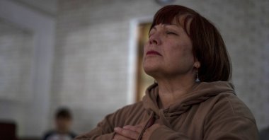 Valentyna Vandysheva, 61, practices yoga in the basement in Kramatorsk, Donetsk region, Ukraine, Sept. 14, 2023. (AP Photo)
