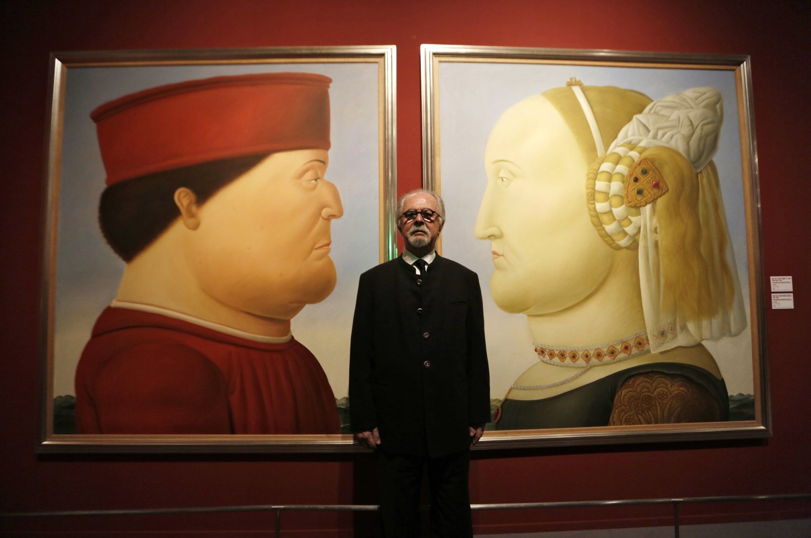 Colombian artist Fernando Botero poses for photos in front of his paintings titled &quot;After Piero Della Francesca&quot; before the opening of his exhibition at the National Museum in Beijing, China, Nov. 20, 2015. (EPA Photo)