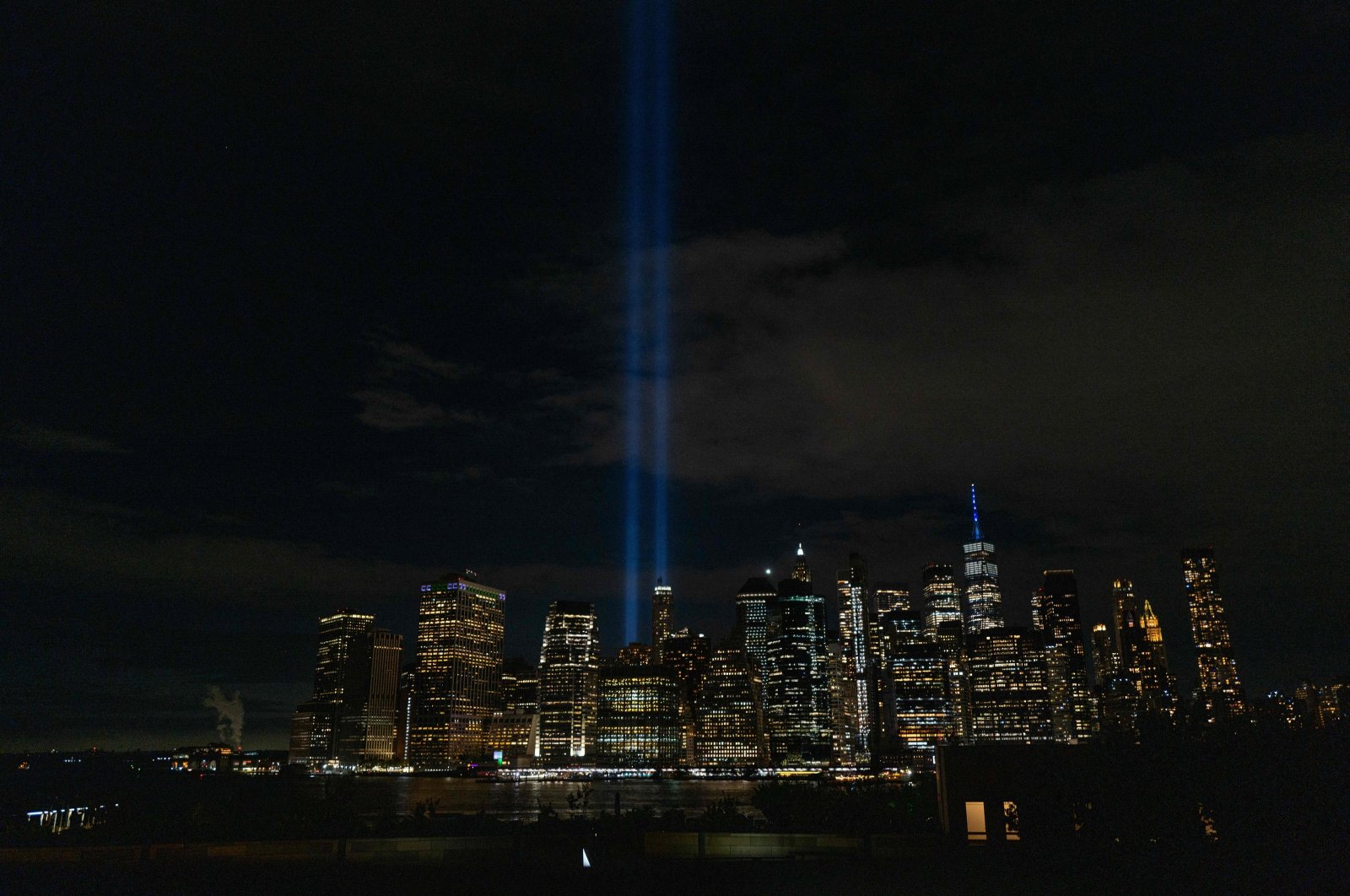 The annual Tribute in Light, which honors the memory of the Twin Towers, is glimpsed from the Brooklyn promenade as the nation commemorates the 22nd anniversary of the attacks in New York City, U.S., Sept. 11, 2023. (AFP Photo)