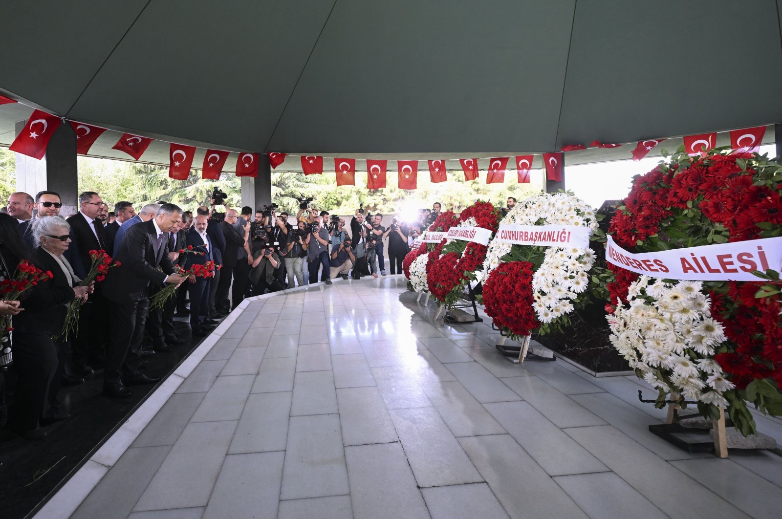 Officials and families lay flowers at the burial site of the late Prime Minister Adnan Menderes, Foreign Minister Fatin Rüştü Zorlu and Finance Minister Hasan Polatkan in Istanbul, Türkiye, Sept. 17, 2023. (AA Photo)