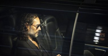 Russell Brand leaves the Troubabour Wembley Park theater after performing a comedy set, London, U.K., Sept. 16, 2023. (AP Photo)
