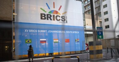 A man walks past a banner as final preparations are underway for the 15th BRICS Summit at the Sandton Convention Centre, Johannesburg, South Africa, Aug. 21, 2023. (EPA Photo)