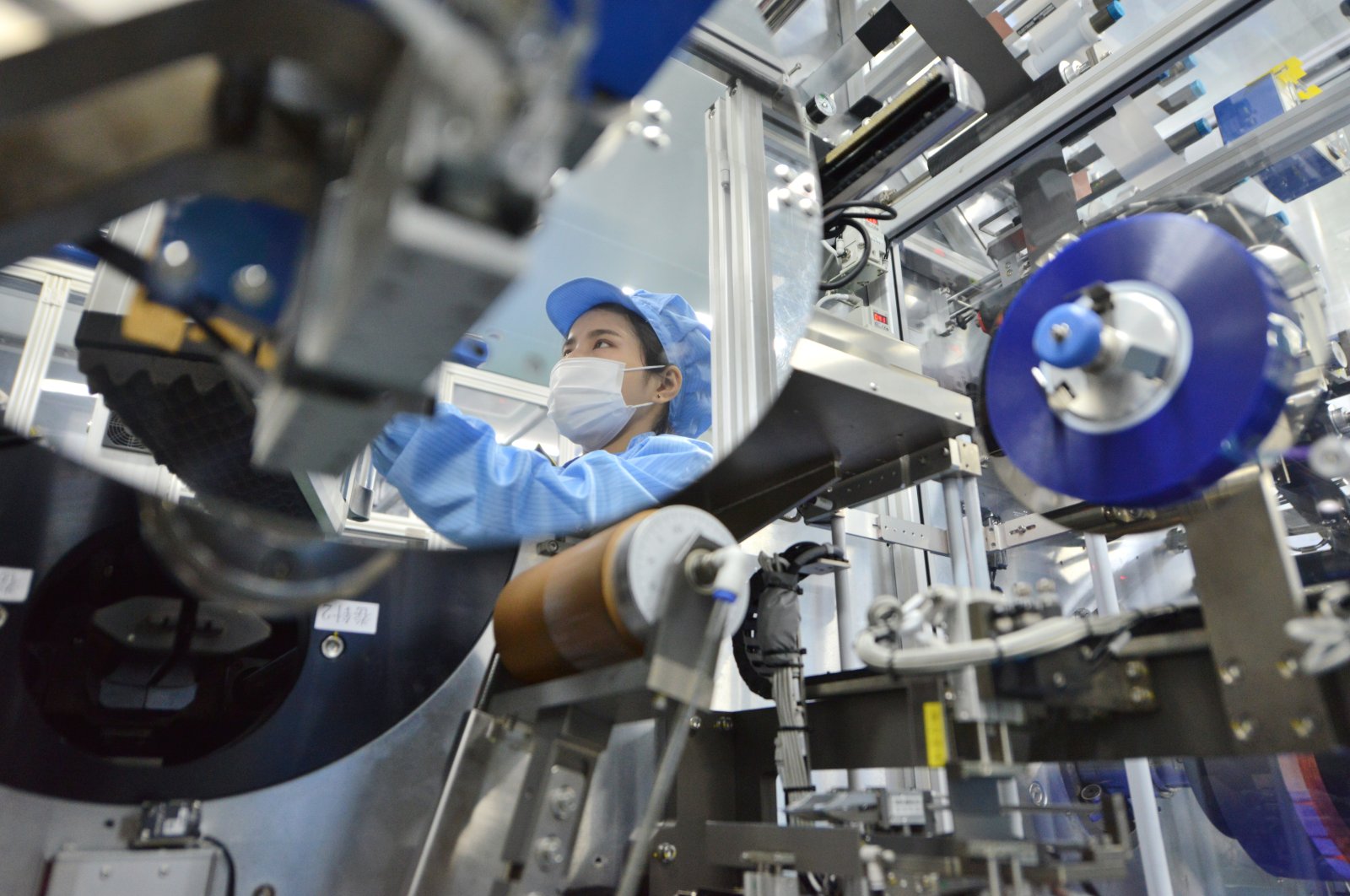 The reflection of a worker is seen at the production line of lithium-ion batteries for electric vehicles (EV) at a factory in Huzhou, Zhejiang province, China, Aug. 28, 2018. (Reuters Photo)