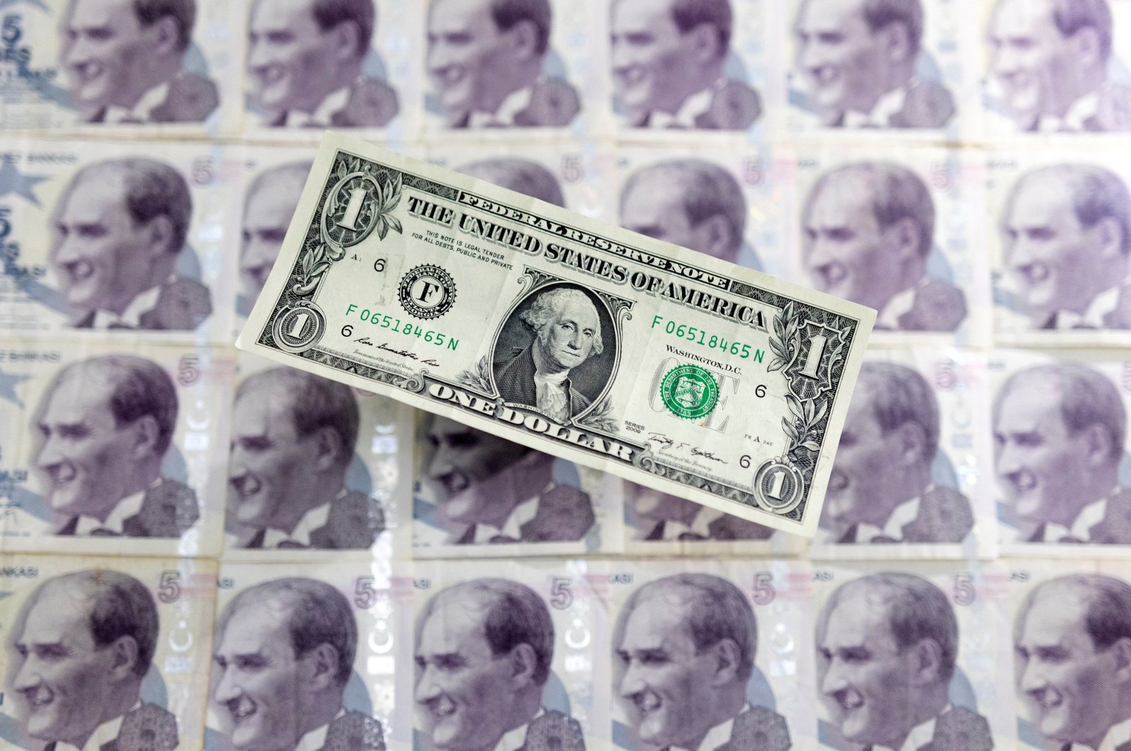 A U.S. dollar banknote is placed on Turkish lira banknotes in this illustration taken on May 30, 2022. (Reuters Photo)