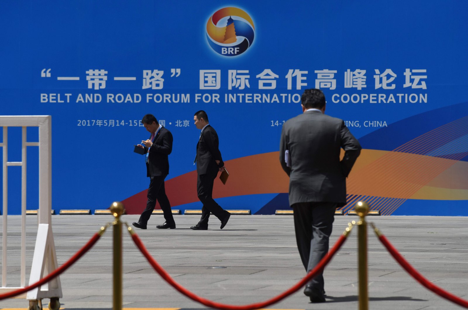 People walk past a billboard for the Belt and Road Forum for International Cooperation in Beijing, China, May 11, 2017. (AFP File Photo)