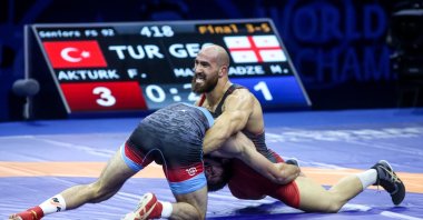 Türkiye's Feyzullah Aktürk in action with Georgian Miriani Maisuradze, in the bronze medal match, Belgrade, Serbia, Sept. 18, 2023. (AA Photo)