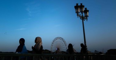 Women wearing an &quot;abaya&quot; walk on a bridge in the southwestern city of Toulouse, France, Sept. 6, 2023. (AFP Photo)
