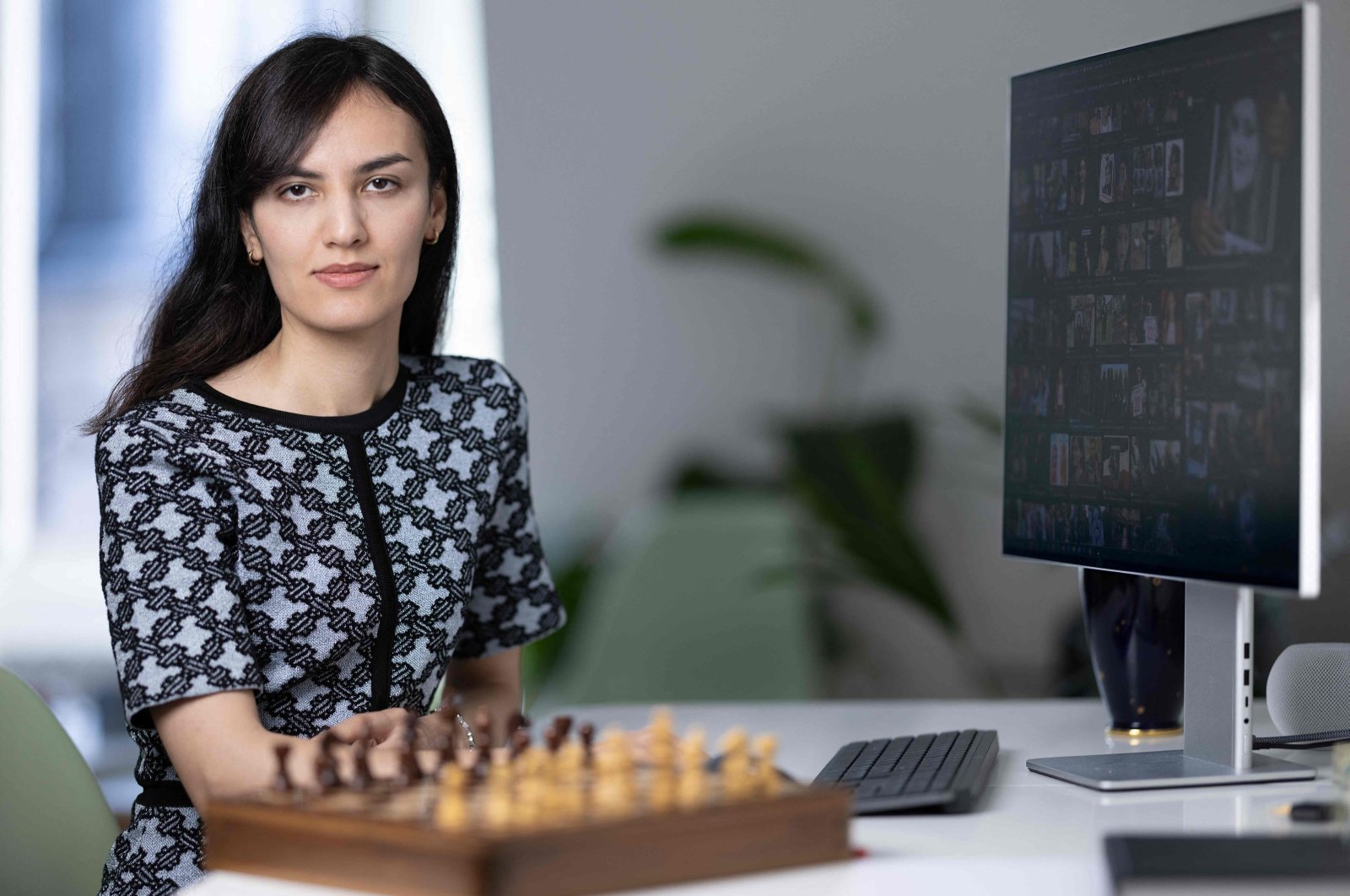 Franco-Iranian chess player Mitra Hejazipour watches Iranian news at home, Paris, France, Sept. 15, 2023. (AFP Photo)