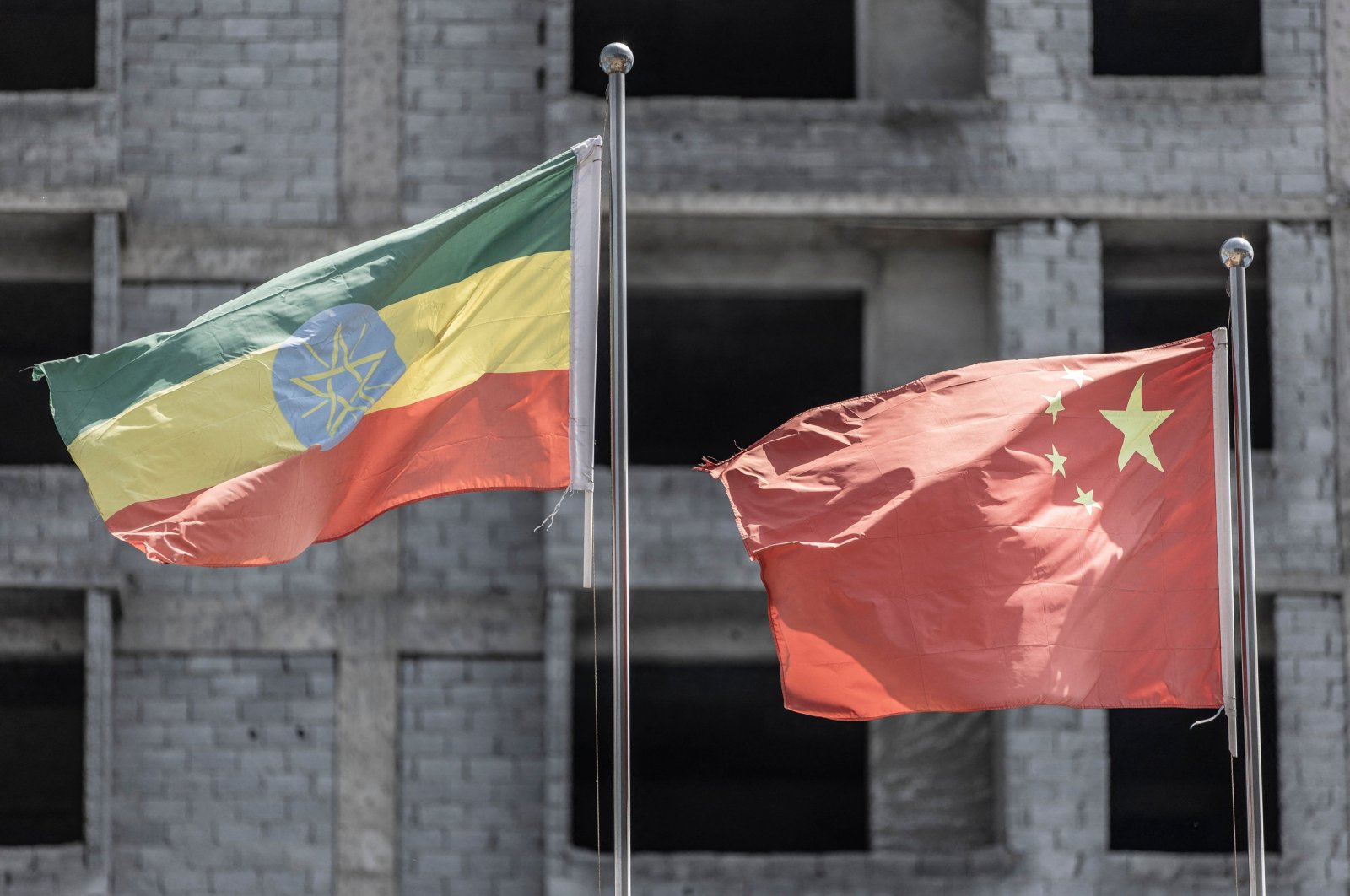 The Ethiopian flag (L) and Chinese flag (R) flutter near a construction site in the Addis-Africa International Convention and Exhibition Center (AAICEC) in Addis Ababa, Ethiopia,  Aug. 31, 2023. (AFP Photo)