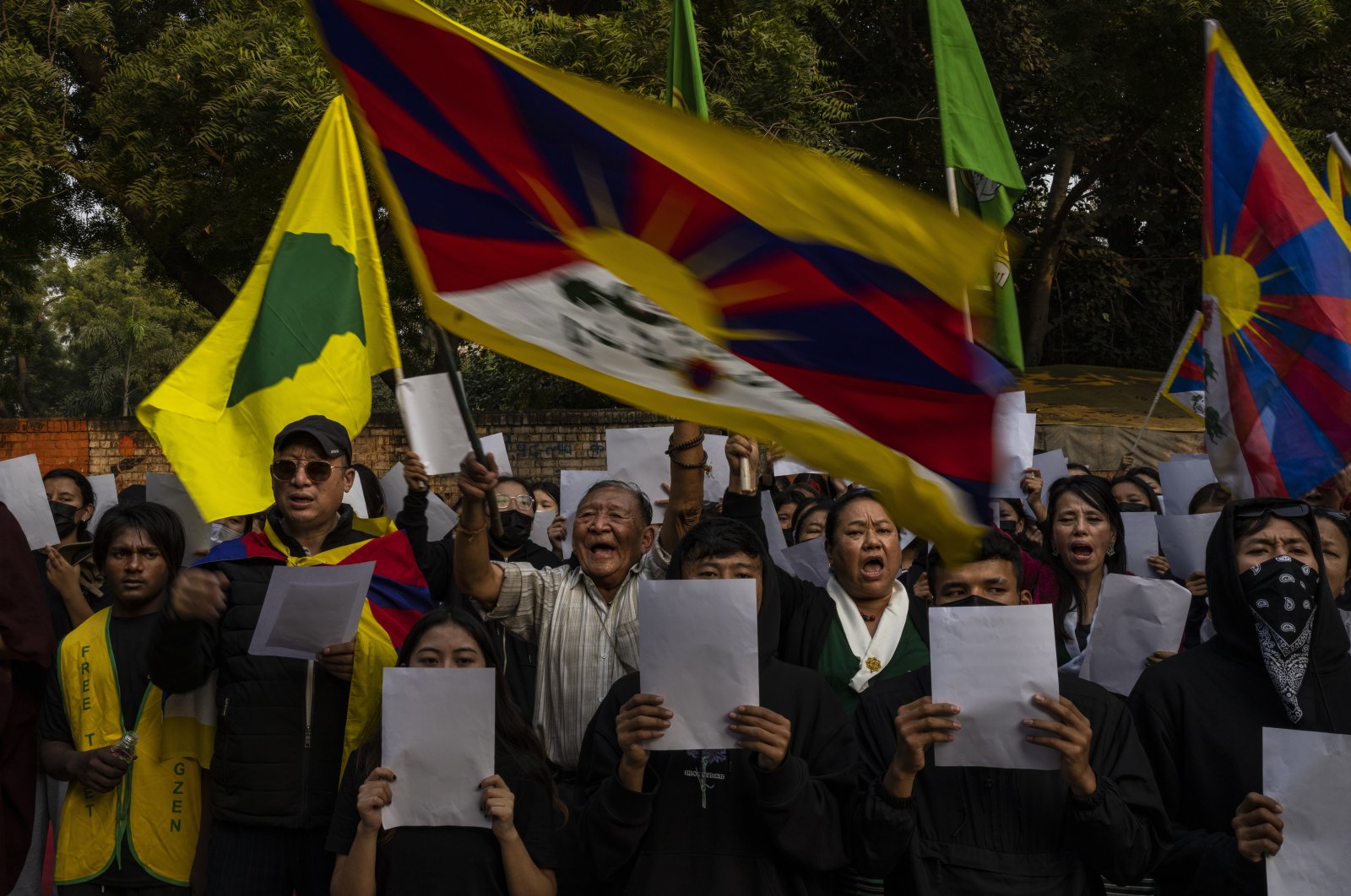 Exile Tibetan activists hold blank white papers symbolizing government censorship in China, while shouting anti-China slogans during a protest in New Delhi, India, Dec. 2, 2022. (AP Photo)