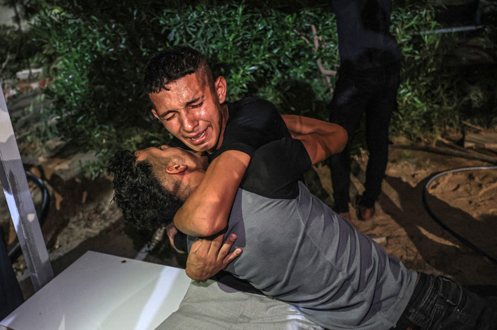 People comfort the brother of a Palestinian killed by the Israeli military in Khan Yunis, southern Gaza Strip, Palestine, Sept. 19, 2023. (AFP Photo)