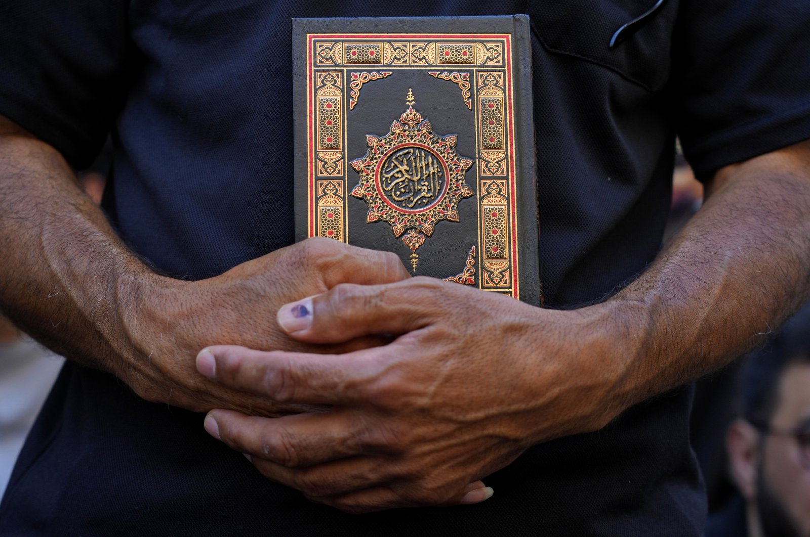 A protester holds the Quran during a rally in Beirut, Lebanon, Friday, July 21, 2023. (AP Photo)