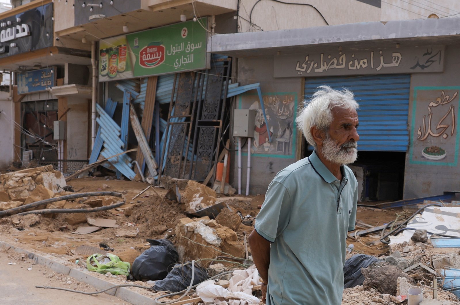 A man walks past rubble and destroyed buildings in flood-hit Derna, Libya, Sept. 19, 2023. (Reuters Photo)