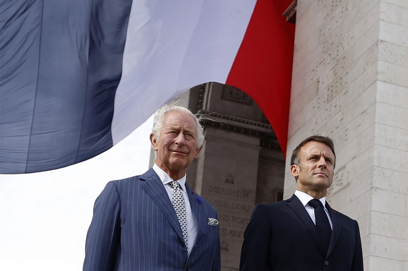 French President Emmanuel Macron (R) and Britain&#039;s King Charles III (L) depart the Arc de Triomphe after an official welcoming ceremony in Paris, France, Sept. 20, 2023. (AFP Photo)