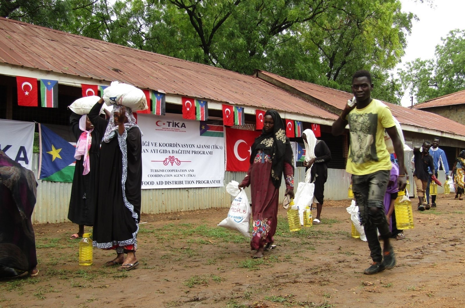 People carry food aid they received from the Turkish Cooperation and Coordination Agency, in Juba, South Sudan, April 26, 2022. (AA File Photo)