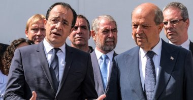 Greek Cypriot President Nikos Christodoulides (L) and Turkish Cypriot leader Ersin Tatar (R) speak to reporters outside the anthropological laboratory of the Committee on Missing Persons in Cyprus (CMP) in the United Nations buffer zone splitting the divided capital Lefkoşa (Nicosia), TRNC, July 28, 2023. (AFP Photo)