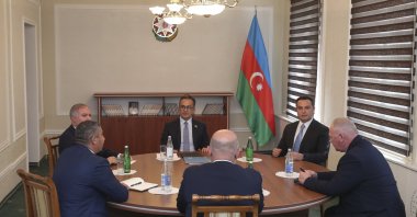 Davit Melkumyan (C, back to camera), Areg Avagyan (L, front) and deputies of the National Assembly of the Nagorno-Karabakh, during talks with Azerbaijani officials headed by Ramin Mamedov (C, rear),  in Yevlakh, Azerbaijan, Sept. 21, 2023. (EPA Photo)