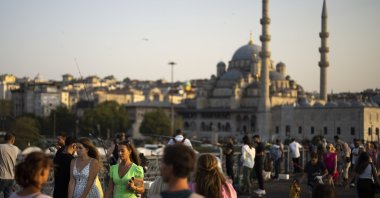 Locals and tourists walk over the Galata bridge in Istanbul, Türkiye, Aug. 16, 2023. (AP Photo)