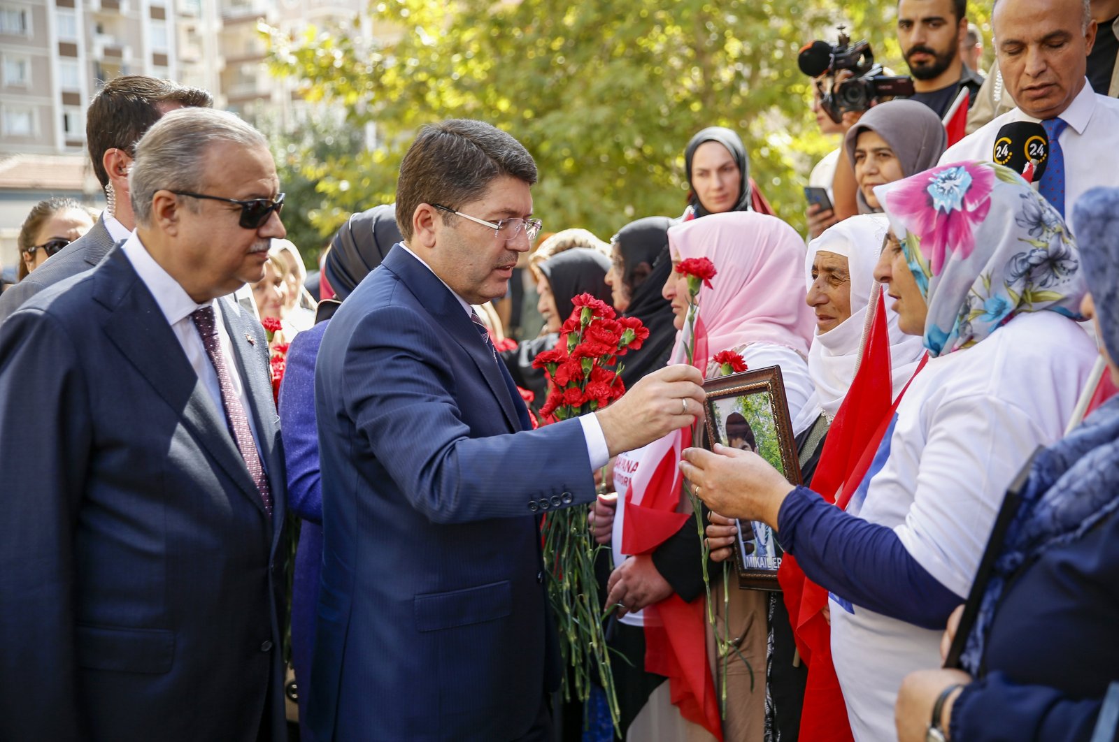 Justice Minister Yılmaz Tunç presents flowers to protesting mothers, in Diyarbakır, southeastern Türkiye, Sept. 22, 2023. (AA Photo)