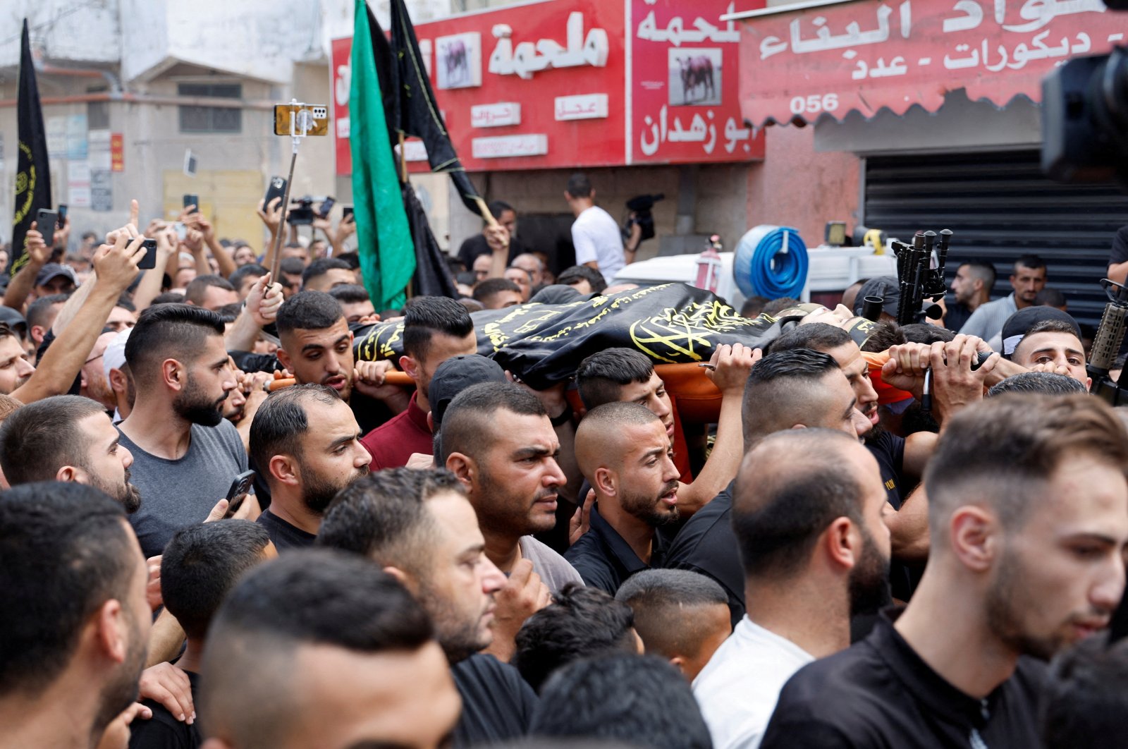 Mourners carry the body of Abdullah Abu Hassan, a Palestinian who was killed in an Israeli raid, during his funeral in Al-Yamoun near Jenin, West Bank, Palestine, Sept. 22, 2023. (Reuters Photo)