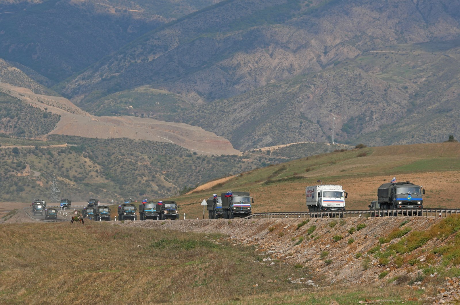 Vehicles of Russian peacekeepers leaving Azerbaijan&#039;s Karabakh region for Armenia pass an Armenian checkpoint on a road near the village of Kornidzor, Armenia Sept. 22, 2023. (Reuters Photo)