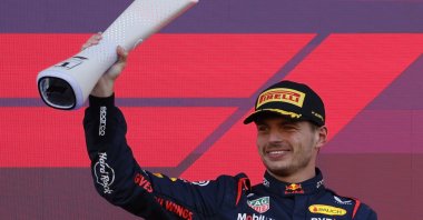 Red Bull&#039;s Max Verstappen celebrates with a trophy on the podium after winning the F1 Japanese Grand Prix, Suzuka, Japan, Sept. 24, 2023. (Reuters Photo)
