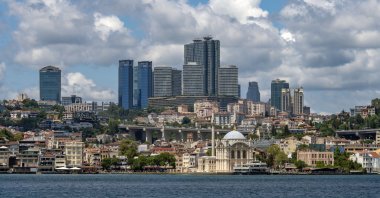 View of the Istanbul skyline with the backdrop of a commercial hub and Ortaköy Mosque, Türkiye. (Getty Images Photo)