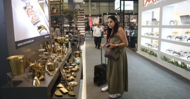 A visitor looks at products on display during the 33rd International Home and Kitchenwares Fair, in Istanbul, Türkiye, Sept. 14, 2023. (AA Photo)