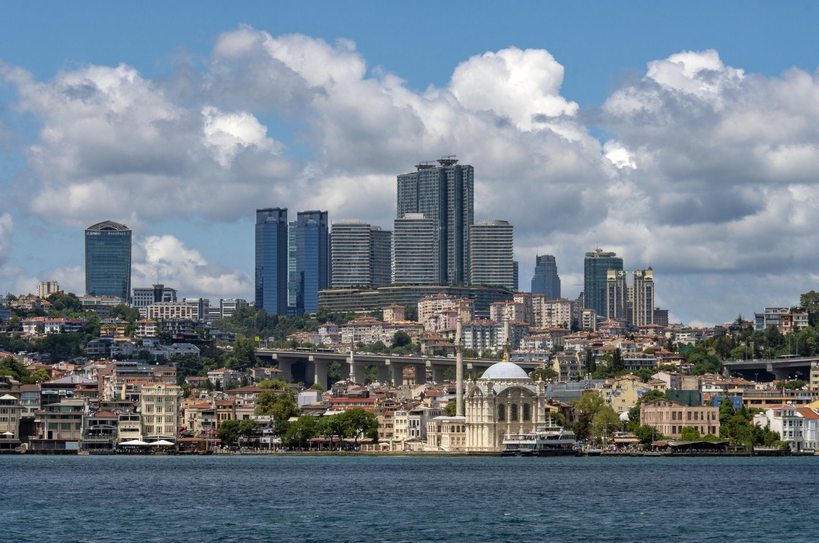 View of the Istanbul skyline with the backdrop of a commercial hub and Ortaköy Mosque, Türkiye. (Getty Images Photo)