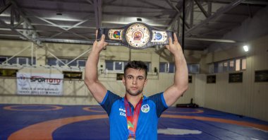 Turkish hearing-impaired wrestler Mükremin Aktaş poses with his belt Sakarya Metropolitan Sports Club, Sakarya, Türkiye, Sept. 19, 2023. (AA Photo)