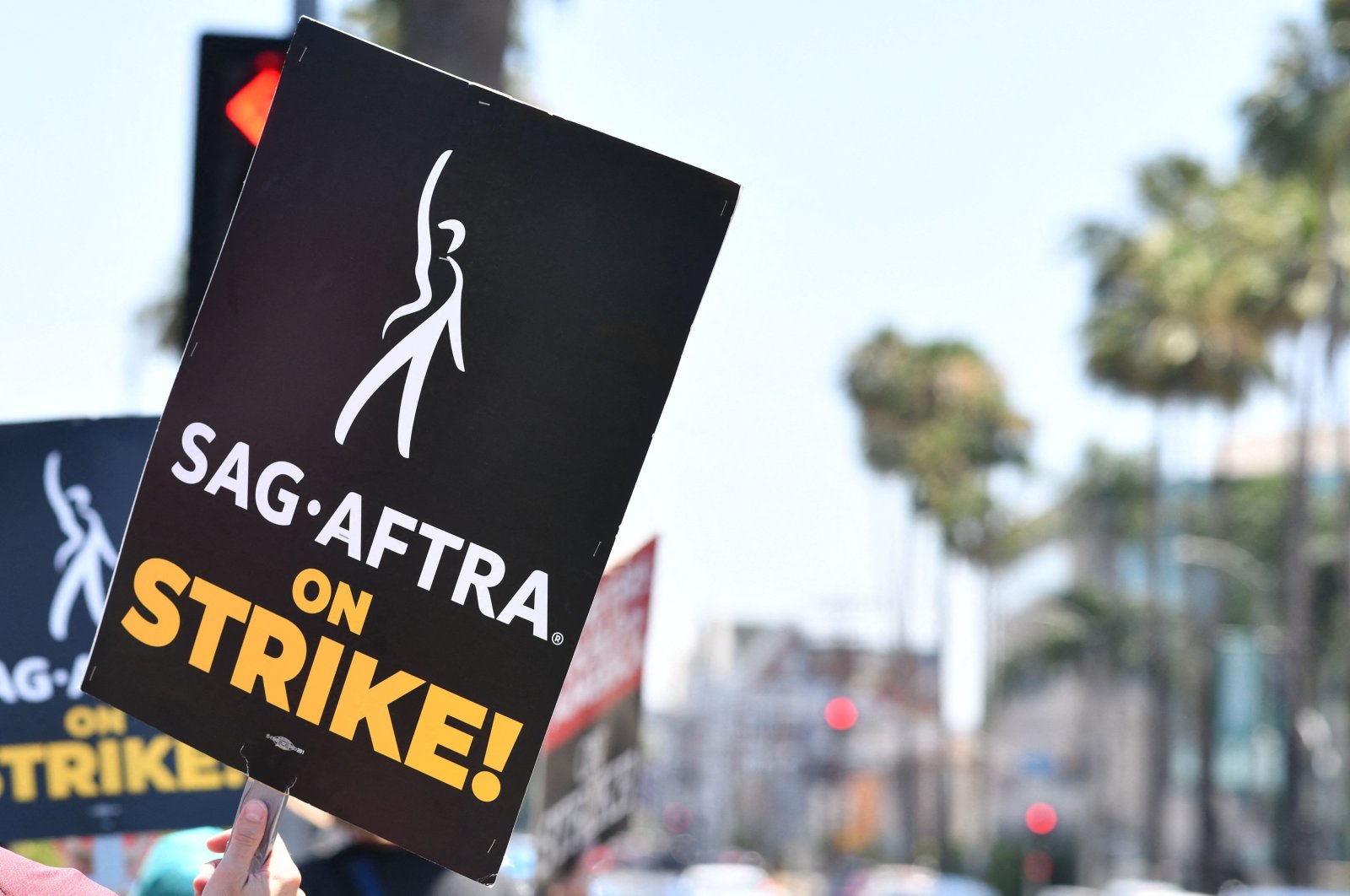 Strike signs are displayed as members of the Writers Guild of America and the Screen Actors Guild walk the picket line outside of Paramount Studios in Los Angeles, California, U.S., July 18, 2023. (AFP Photo)