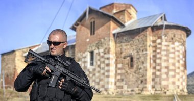 An armed Kosovo police officer stands guard along a road near the village of Banjska, Kosovo, Sept. 26, 2023. (EPA Photo)