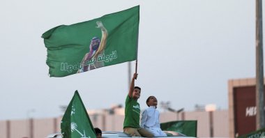 Saudi&#039;s youth hold Saudi National flag while participating in a carnival celebrating Saudi Arabia&#039;s National Day in Riyadh, Saudi Arabia, Sept. 23, 2023. (Reuters Photo)