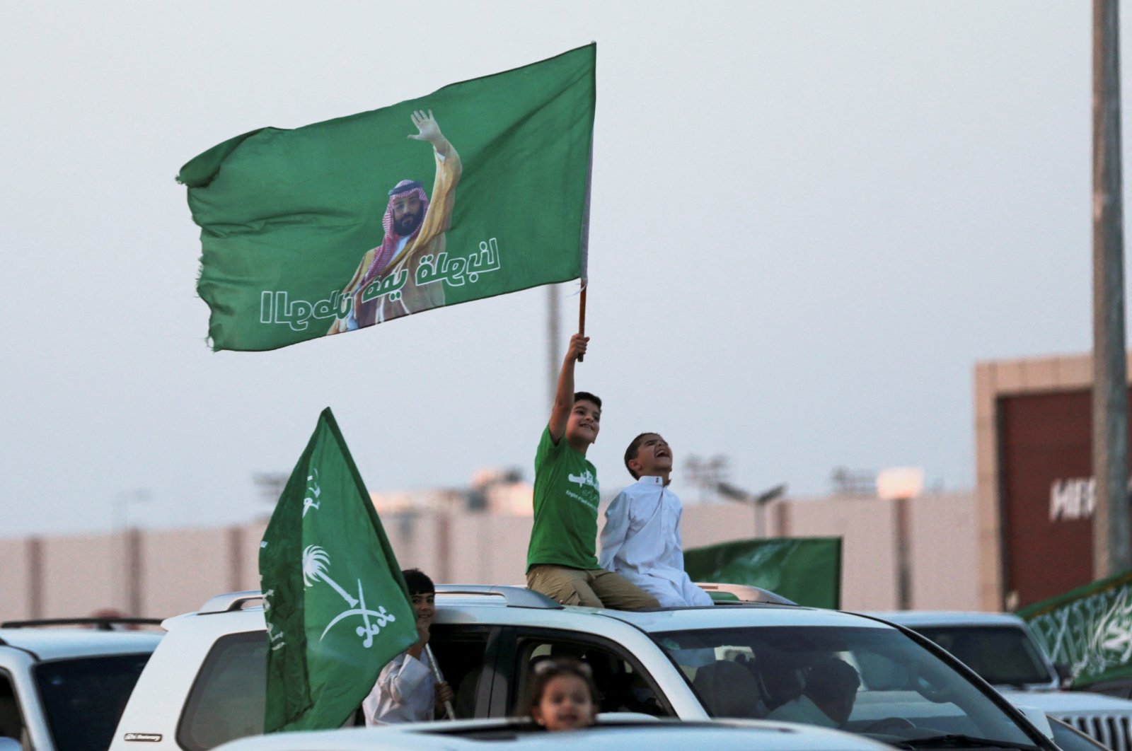 Saudi&#039;s youth hold Saudi National flag while participating in a carnival celebrating Saudi Arabia&#039;s National Day in Riyadh, Saudi Arabia, Sept. 23, 2023. (Reuters Photo)