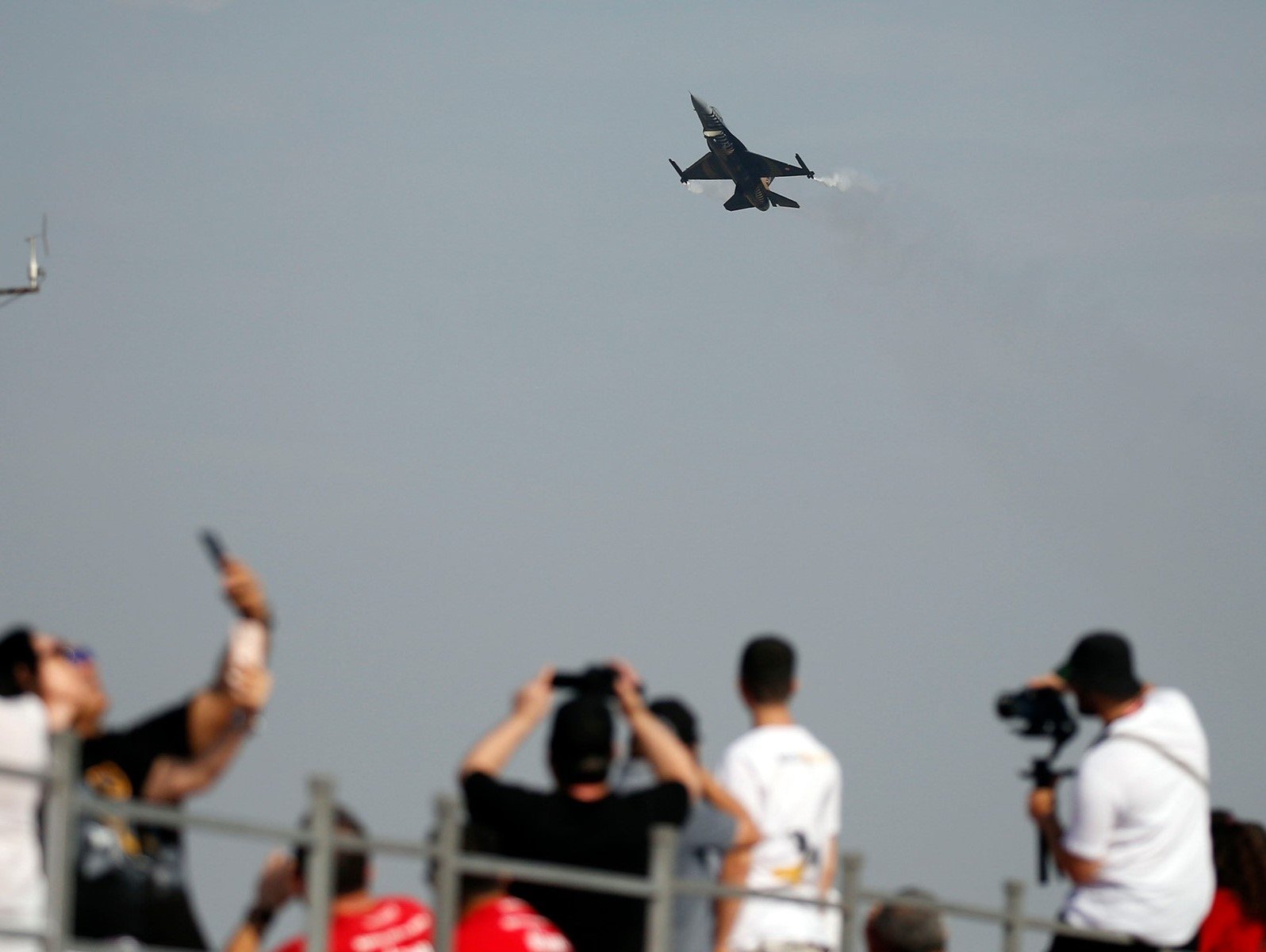 Visitors at Teknofest Izmir click photos during an air show, Türkiye, Sept. 27, 2023. (AA Photo)