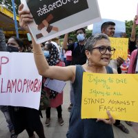 People carry placards and shout slogans during a protest in Bengaluru, India, Saturday, April 30, 2022. (AP File Photo)