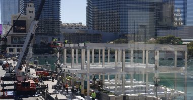 Workers stand at a Formula One construction site at the Bellagio fountains, Las Vegas, US., Sept. 25, 2023. (AP Photo)