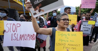 People carry placards and shout slogans during a protest in Bengaluru, India, Saturday, April 30, 2022. (AP File Photo)