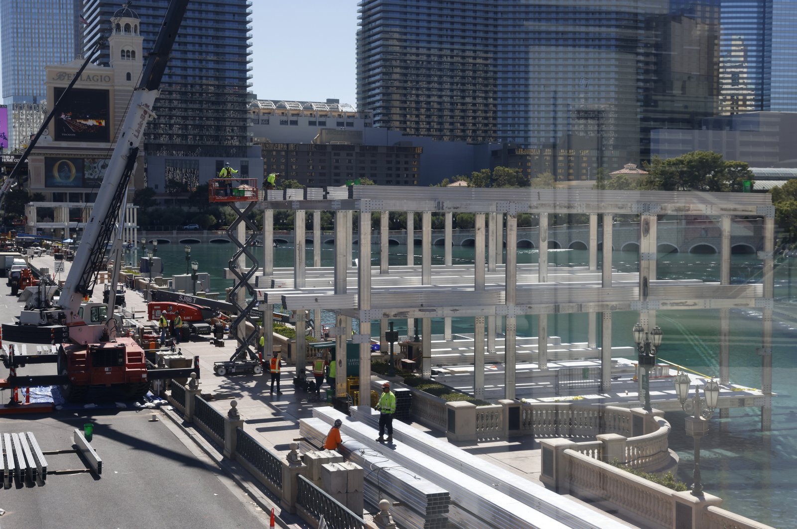 Workers stand at a Formula One construction site at the Bellagio fountains, Las Vegas, US., Sept. 25, 2023. (AP Photo)