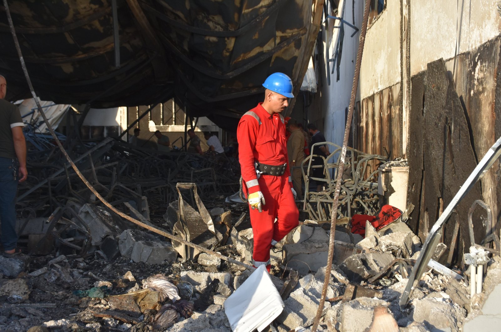 A firefighter scans through the rubble of the building burned down by the fire in Mosul, Iraq, Sept. 27, 2023. (AA Photo)