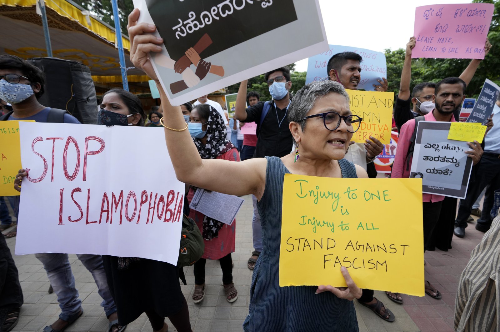 People carry placards and shout slogans during a protest in Bengaluru, India, Saturday, April 30, 2022. (AP File Photo)