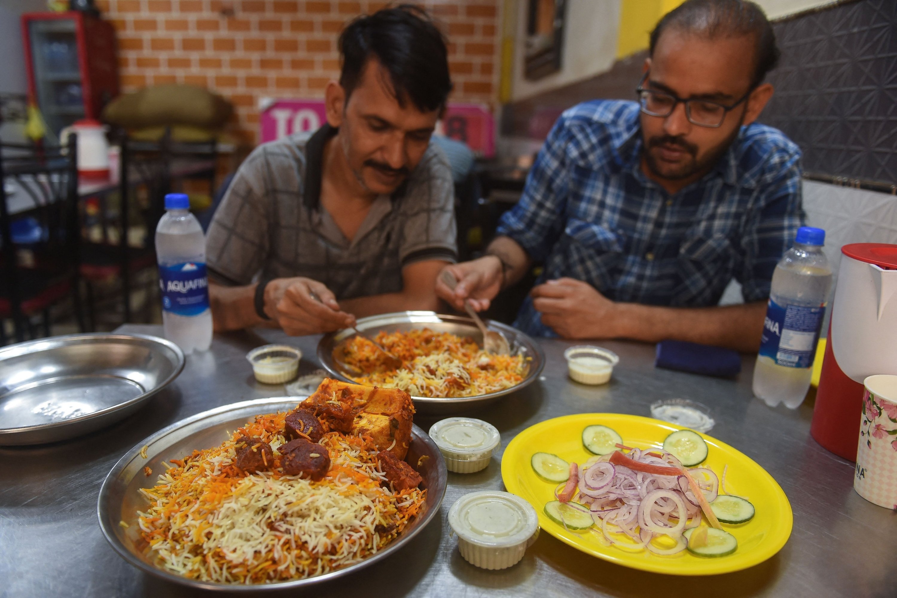 People eat biryani at a restaurant in Karachi, Pakistan, Sept. 19, 2023. (AFP Photo)