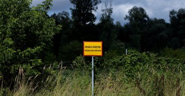 A sign reading &quot;State border. Crossing prohibited&quot; is seen near the Bug River at the Poland-Belarus border, near Kostomloty, Poland, July 20, 2023. (Reuters Photo)