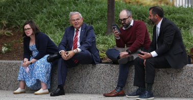 Senator Bob Menendez (D-NJ) sits with staff outside the Hart Senate Office Building in Washington, D.C., U.S., Sept. 28, 2023. (AFP Photo)