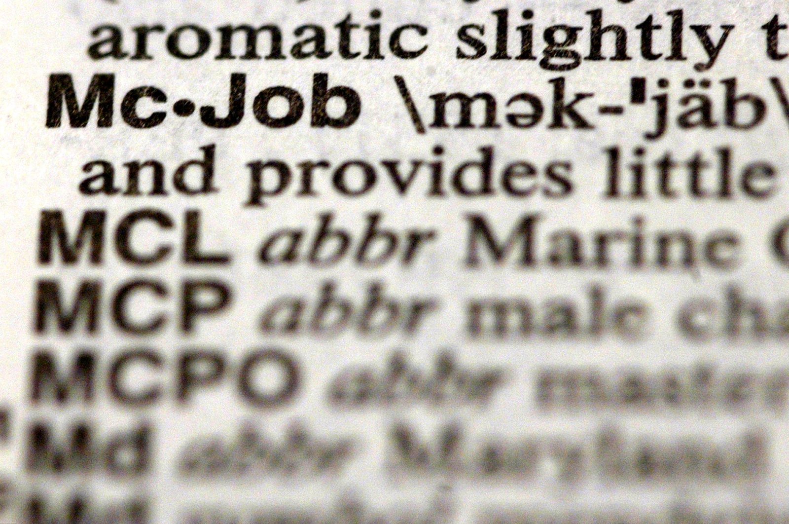 The word "McJob" is seen in a Merriam-Webster&#039;s Collegiate Dictionary in a bookstore Illinois, U.S., Nov. 10, 2003. (Getty Images Photo)