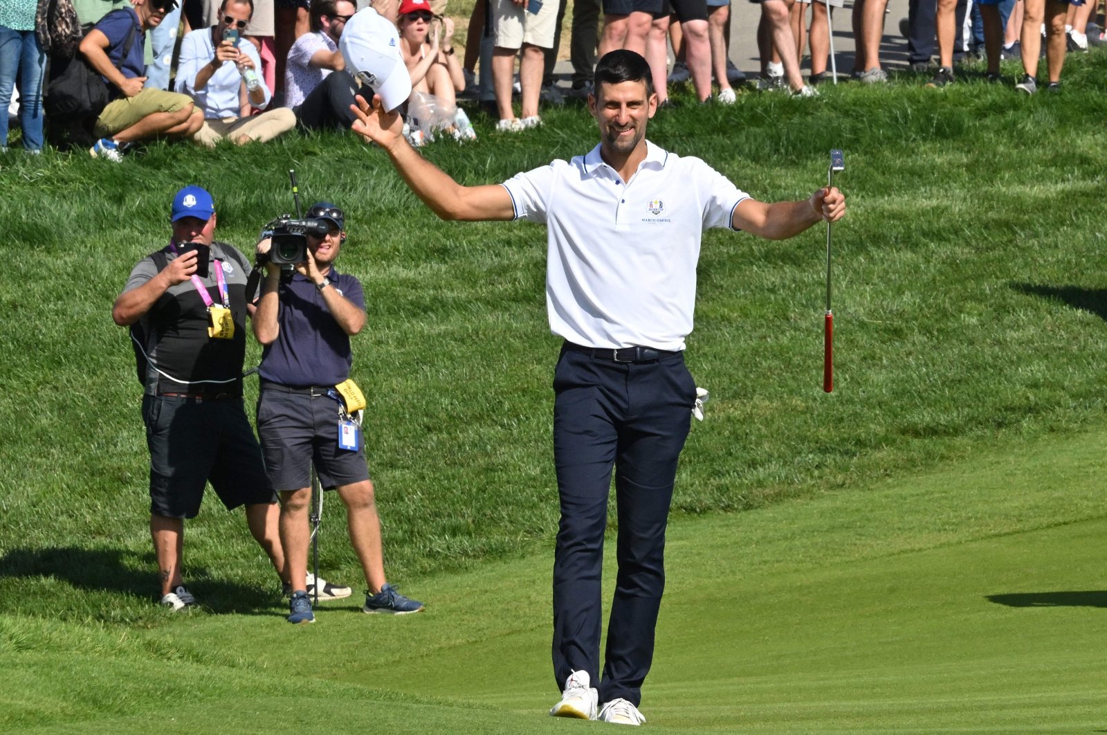 Serbian tennis player Novak Djokovic acknowledges the applause from the spectators as he walks to the 18th green during the All-Star match played ahead of the 44th Ryder Cup at the Marco Simone Golf and Country Club, Rome, Italy, Sept. 27, 2023. (AFP Photo)