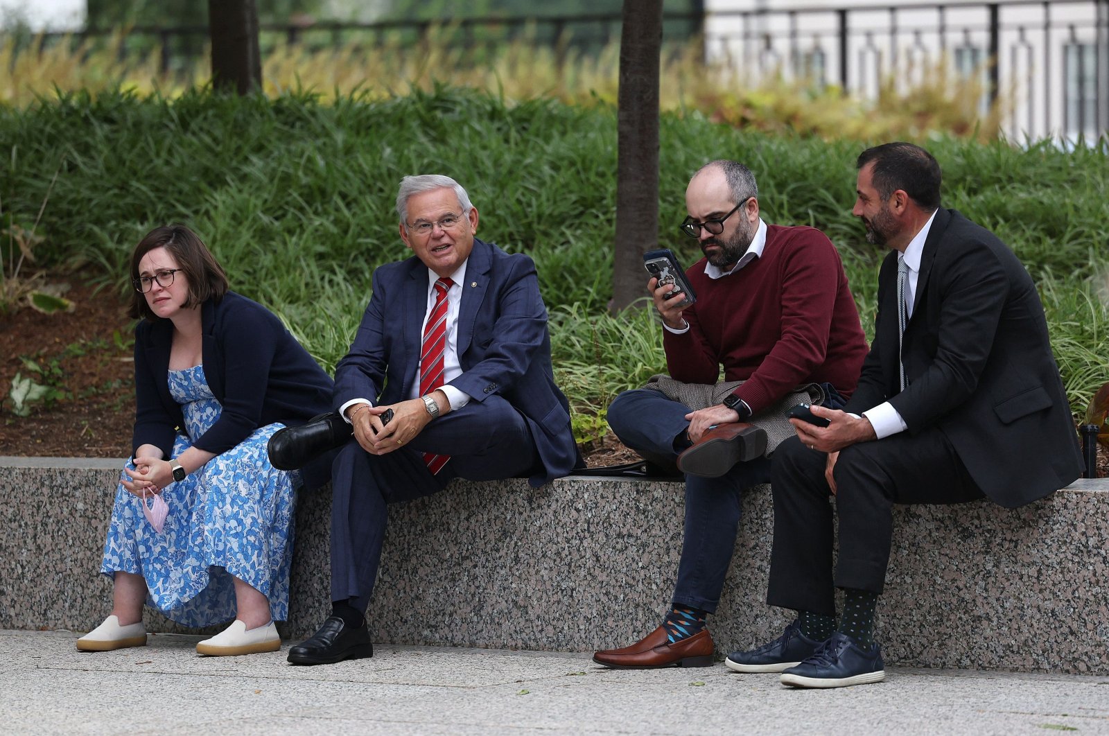Senator Bob Menendez (D-NJ) sits with staff outside the Hart Senate Office Building in Washington, D.C., U.S., Sept. 28, 2023. (AFP Photo)