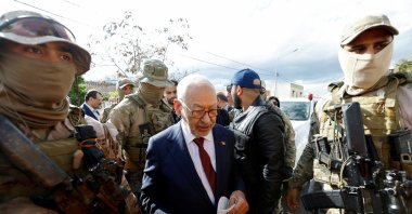 Tunisia's Rached Ghannouchi, head of the Ennahda party, is surrounded by presidential guard members in Tunis, Tunisia, April 1, 2022. (Reuters Photo)