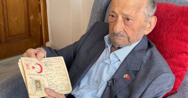 Mustafa Reşberoğlu, a Korean War veteran, poses with his old ID card, Sarıyer, Istanbul, Türkiye, Sept. 29, 2023. (AA Photo)