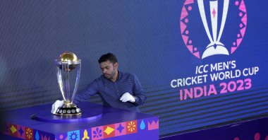 An official wipes the ICC Cricket World Cup trophy before its unveiling at the Eden Gardens, Kolkata, India, Sept. 8, 2023. (AP Photo)